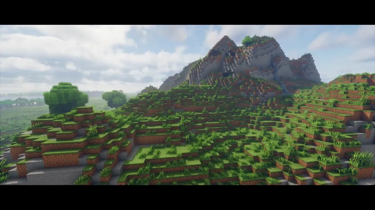 A green mountainside under broken cloud